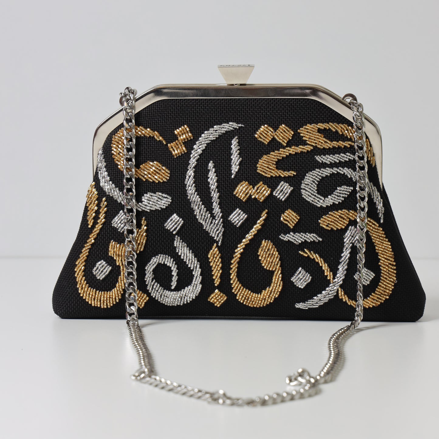 CALLIGRAPHY TRAPEZE CLUTCH